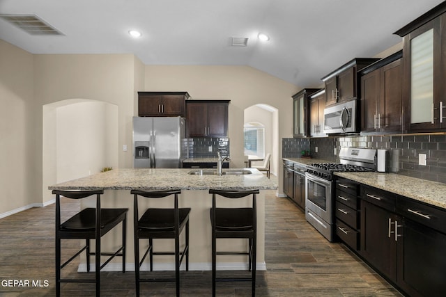 kitchen with a center island with sink, dark hardwood / wood-style floors, sink, and appliances with stainless steel finishes