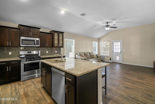 kitchen featuring dark hardwood / wood-style floors, lofted ceiling, sink, and appliances with stainless steel finishes