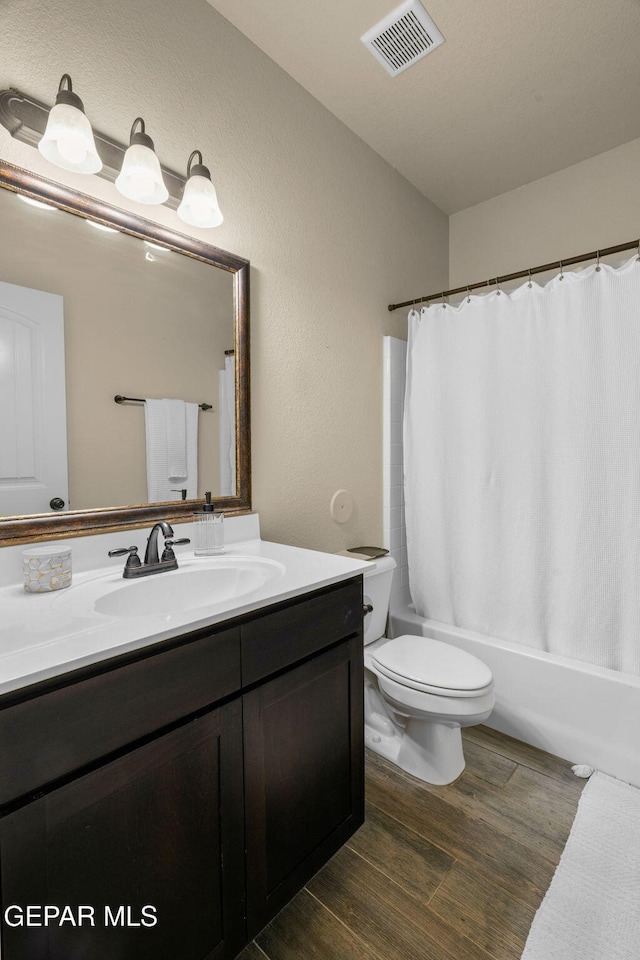 full bathroom with toilet, vanity, shower / bath combination with curtain, and hardwood / wood-style flooring