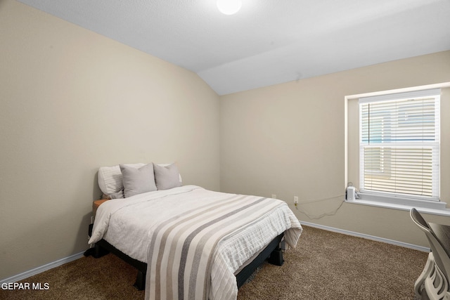 bedroom with dark colored carpet and lofted ceiling