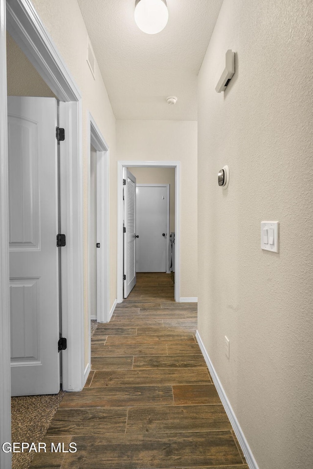 corridor with dark wood-type flooring