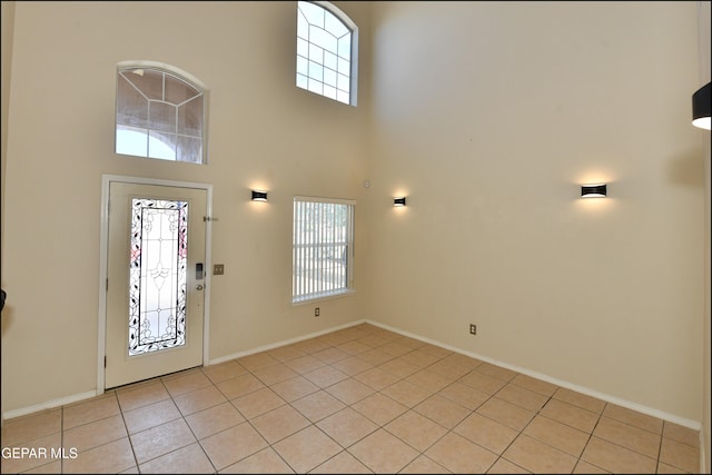 tiled foyer entrance featuring a high ceiling