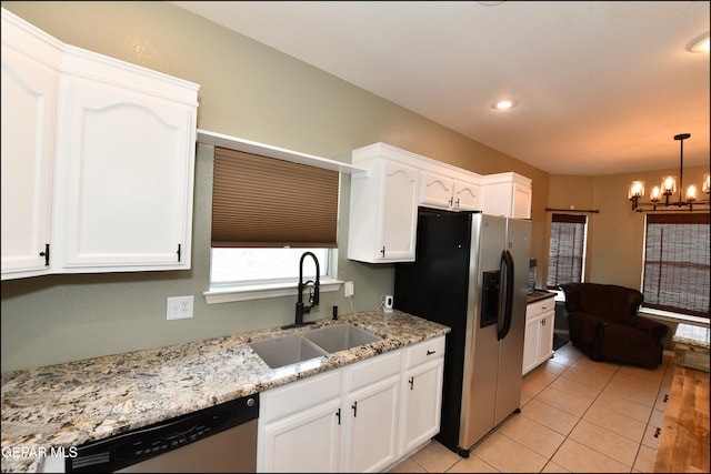 kitchen with sink, hanging light fixtures, stainless steel appliances, a chandelier, and white cabinets