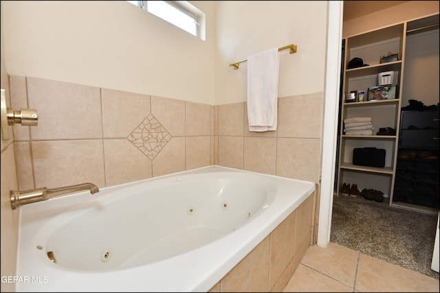 bathroom with tile patterned flooring and a relaxing tiled tub