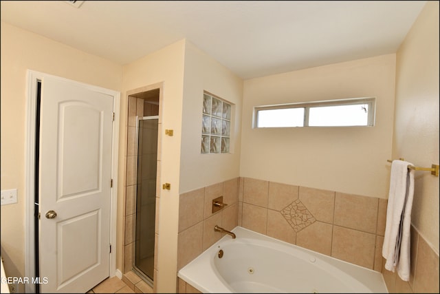 bathroom with tile patterned floors and separate shower and tub