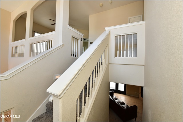 staircase featuring tile patterned flooring