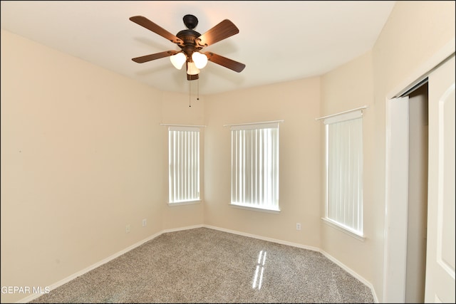 unfurnished room with ceiling fan and carpet floors