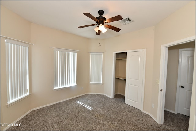 unfurnished bedroom with carpet flooring, ceiling fan, and a closet