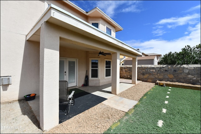 exterior space featuring ceiling fan