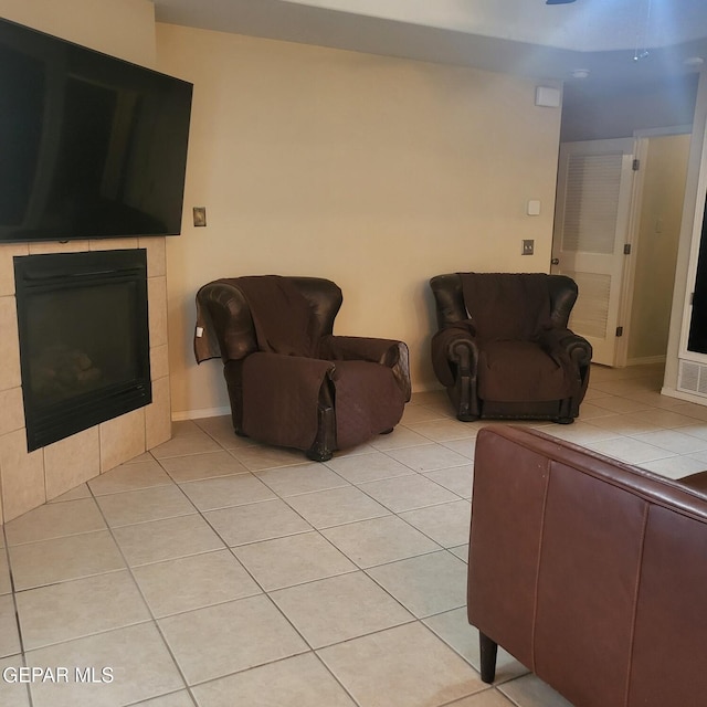 tiled living room featuring a tile fireplace