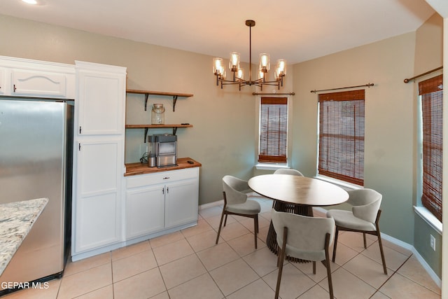 tiled dining space with an inviting chandelier