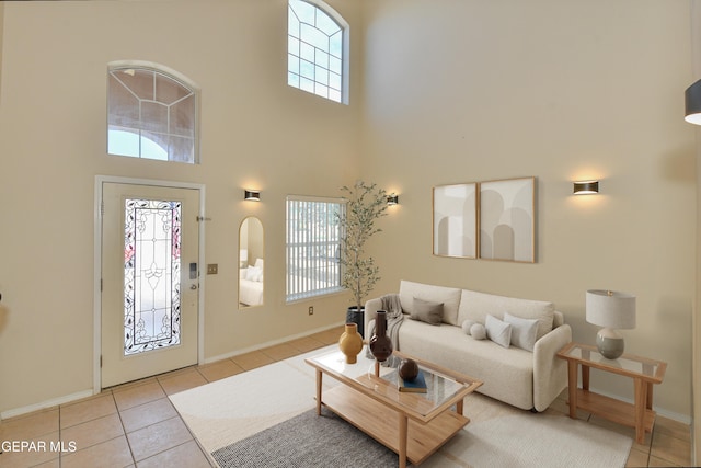 living room featuring light tile patterned floors and a high ceiling