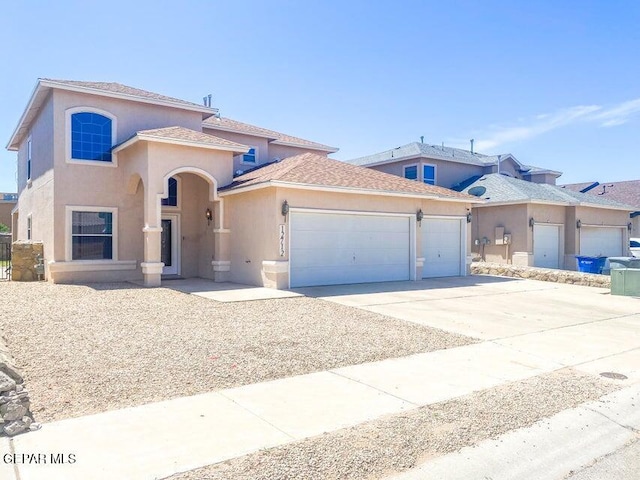 12712 Tierra Aurora Dr, El Paso, TX 79938 - mediterranean / spanish house with an attached garage, stucco siding, and driveway