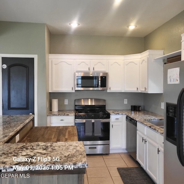 12712 Tierra Aurora Dr, El Paso, TX 79938 - kitchen with stainless steel appliances, white cabinets, and stone counters