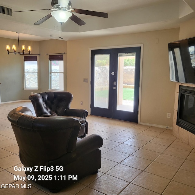 12712 Tierra Aurora Dr, El Paso, TX 79938 - tiled living room with french doors, baseboards, a chandelier, and ceiling fan