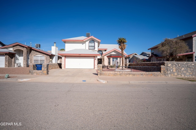 front of property with a garage and central AC