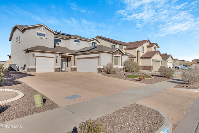 view of front of home with solar panels, cooling unit, and a garage