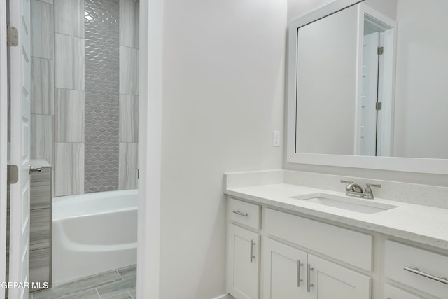 bathroom featuring vanity and tiled shower