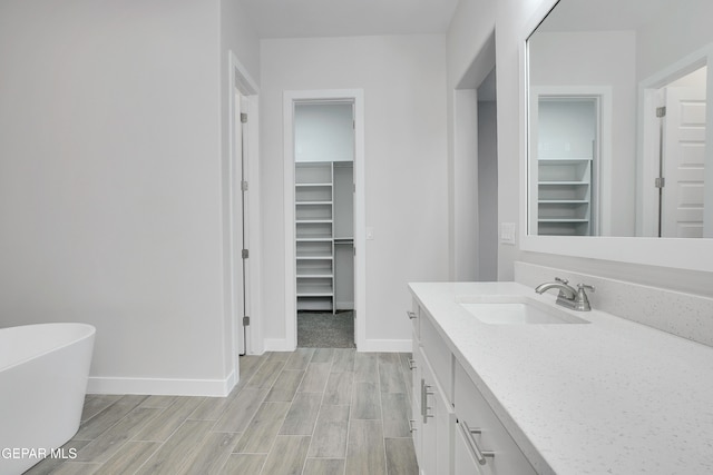 bathroom with vanity and a tub to relax in