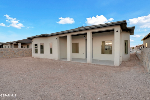 rear view of property featuring a patio area