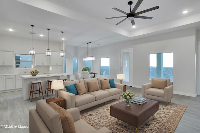 living room featuring recessed lighting, light wood-style floors, a healthy amount of sunlight, and ceiling fan