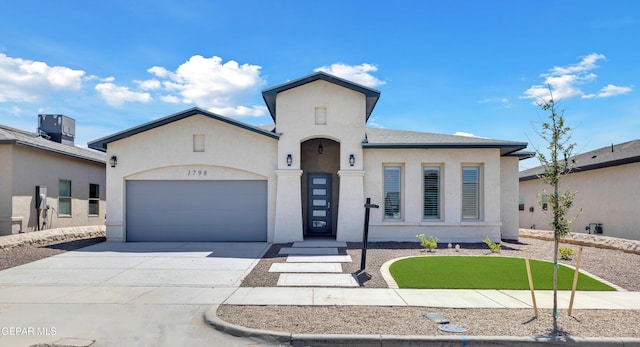 1798 Dana Gray St, El Paso, TX 79928 - view of front of house with stucco siding, an attached garage, driveway, and central AC
