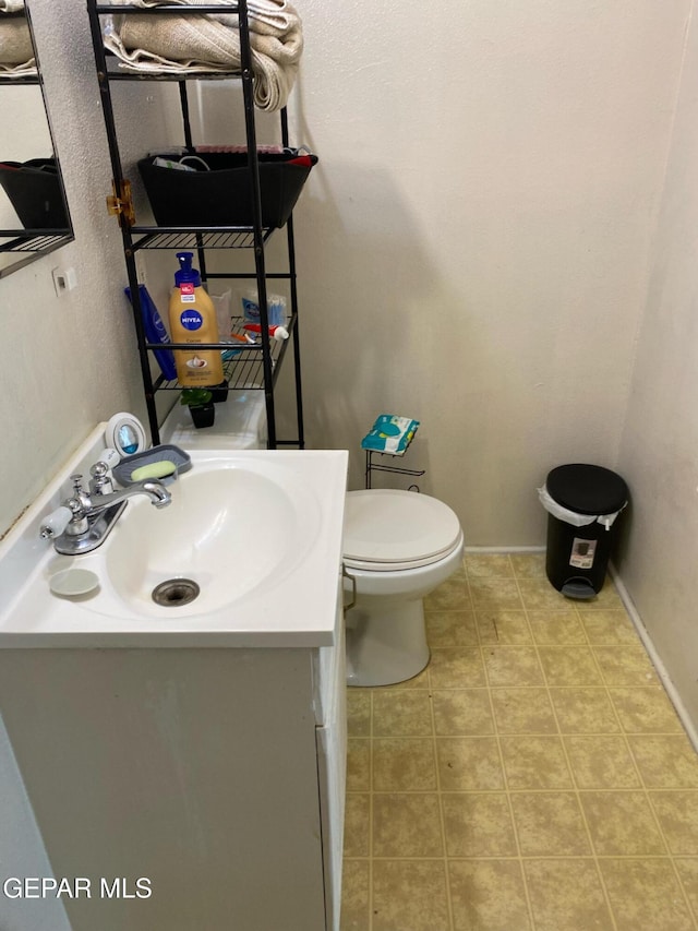 bathroom featuring tile patterned floors, vanity, and toilet