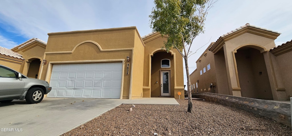 mediterranean / spanish-style house featuring a garage