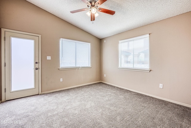 carpeted spare room with lofted ceiling, ceiling fan, and a textured ceiling