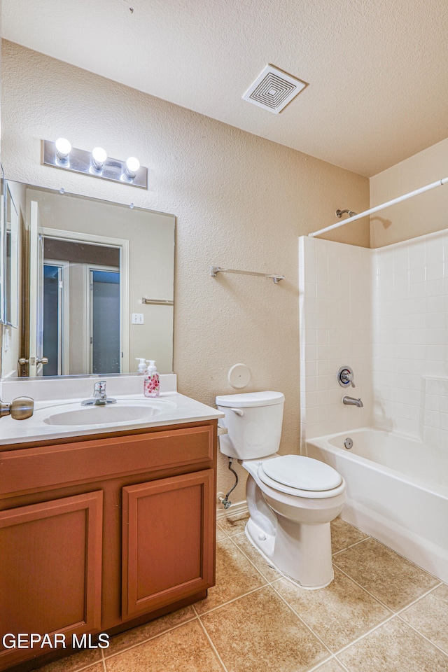 bathroom featuring visible vents, toilet, a textured ceiling, vanity, and tile patterned flooring