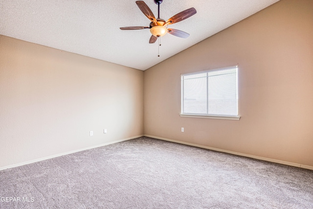 carpeted spare room featuring lofted ceiling, a textured ceiling, a ceiling fan, and baseboards