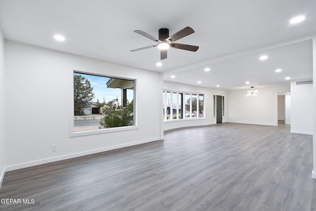 unfurnished living room with ceiling fan and wood-type flooring