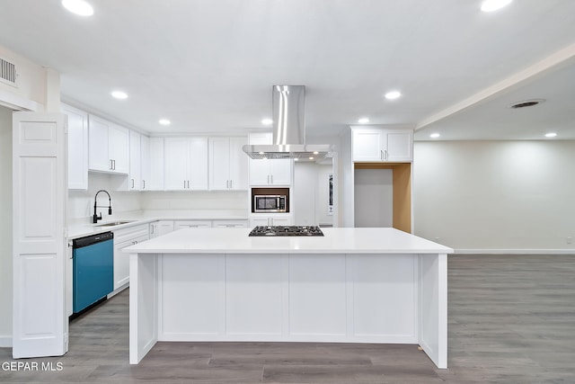 kitchen featuring island range hood, a kitchen island, white cabinetry, and appliances with stainless steel finishes