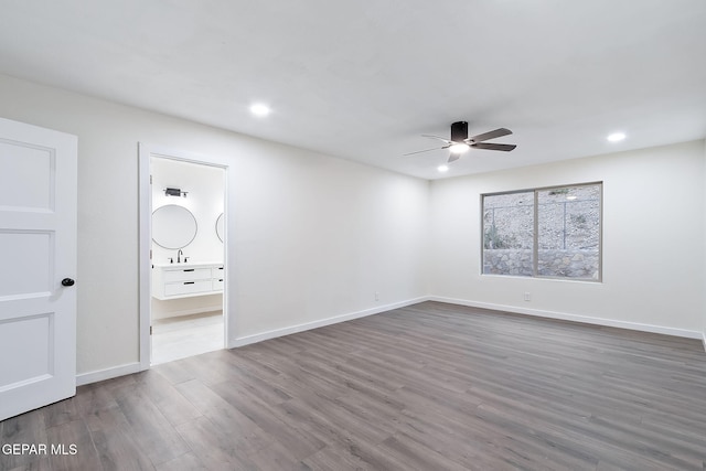 unfurnished bedroom with sink, ensuite bathroom, ceiling fan, and dark hardwood / wood-style floors