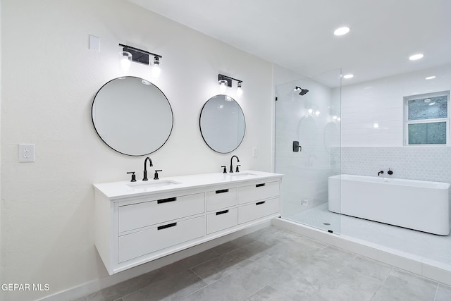 bathroom with plus walk in shower, vanity, and tile patterned flooring