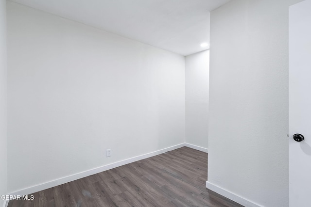 empty room with dark hardwood / wood-style flooring