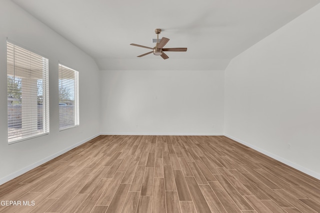 spare room with ceiling fan, light hardwood / wood-style flooring, and lofted ceiling