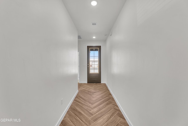 doorway with light parquet flooring