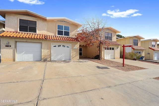 mediterranean / spanish-style home with a garage