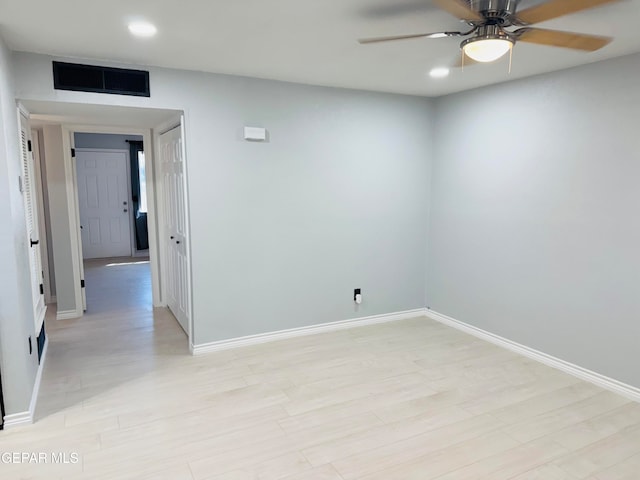 spare room with light hardwood / wood-style floors and ceiling fan