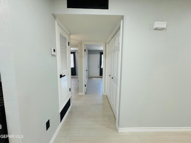 hall with light hardwood / wood-style floors