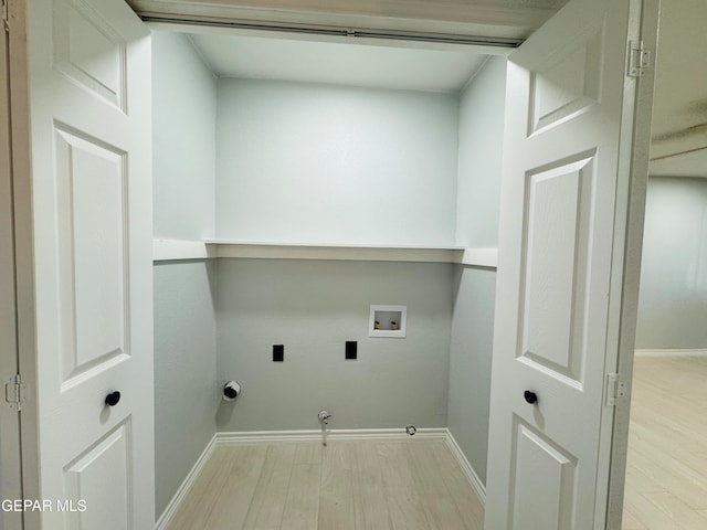 clothes washing area with washer hookup, light hardwood / wood-style floors, gas dryer hookup, and hookup for an electric dryer