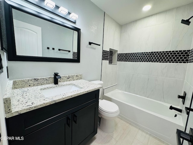 full bathroom with tile patterned floors, toilet, vanity, and tiled shower / bath