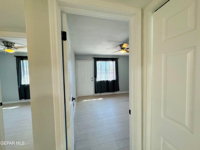 corridor with light wood-type flooring