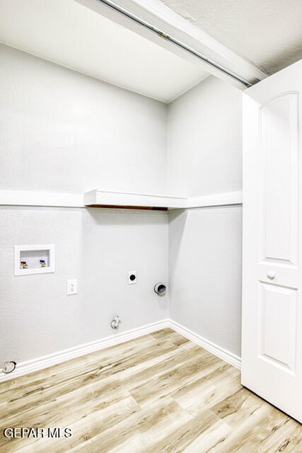 laundry room featuring washer hookup, electric dryer hookup, gas dryer hookup, and light wood-type flooring