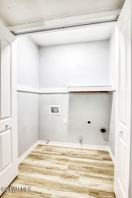 washroom featuring gas dryer hookup, hookup for a washing machine, hookup for an electric dryer, and hardwood / wood-style flooring