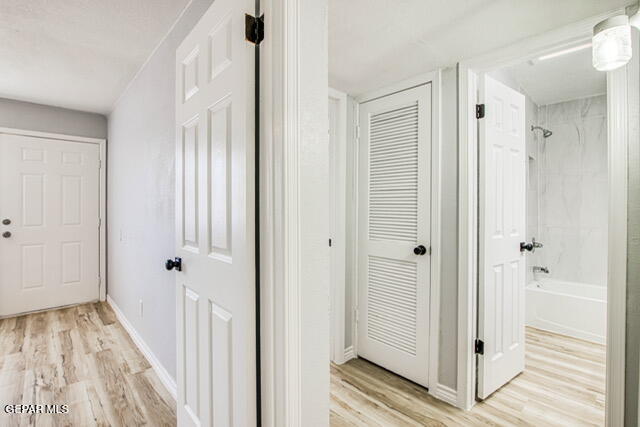 corridor featuring light hardwood / wood-style flooring