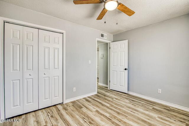 unfurnished bedroom with a closet, ceiling fan, and light hardwood / wood-style flooring