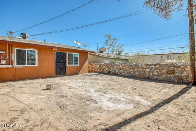 rear view of property featuring central AC unit