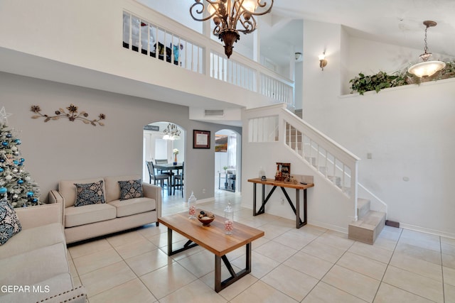 living room with a notable chandelier, light tile patterned flooring, and high vaulted ceiling